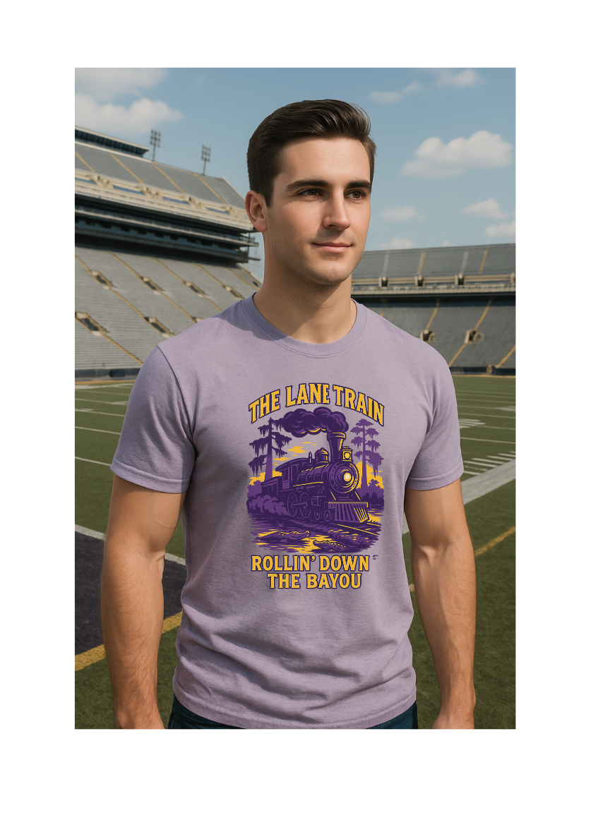 Man wearing a Lane Train Rollin' Down the Bayou purple t-shirt with a train graphic and text in an outdoor stadium setting