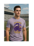 Man wearing a Lane Train Rollin' Down the Bayou purple t-shirt with a train graphic and text in an outdoor stadium setting